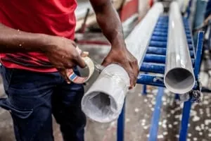 staff at dw plastics packaging up the plastic pipes